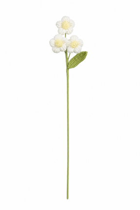Hvid hæklet blomsterstilk med tre små blomster med gul midte og grønt blad