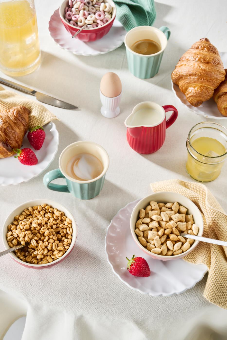 Strawberry rød Mynte mælkekande på morgenbord med croissanter, müsli, kaffe og frisk frugt