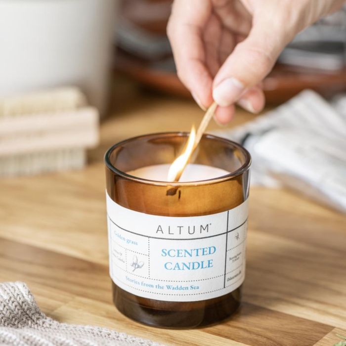 En brændende tændstik tænder et Ib Laursen ALTUM Golden Grass duftlys